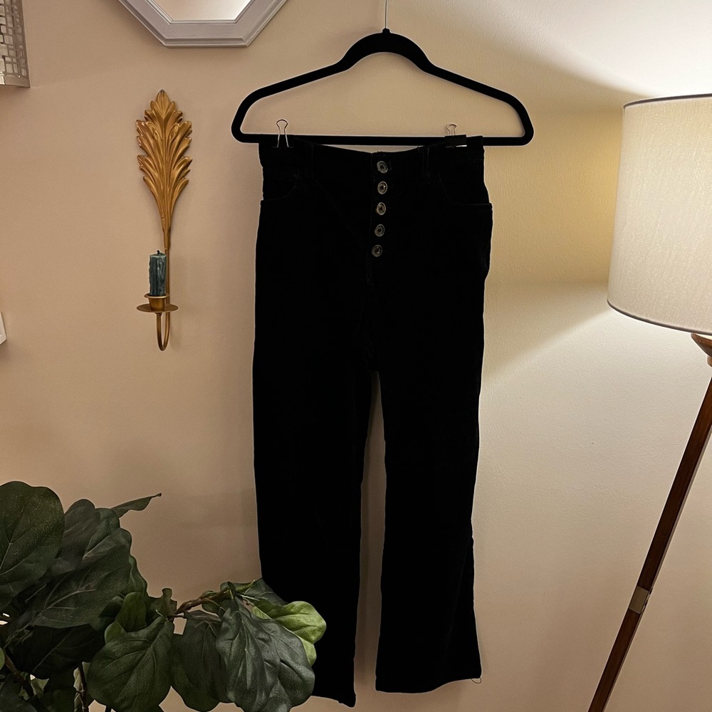 Black corduroy pants with slight flare, high waisted with 5 button detail